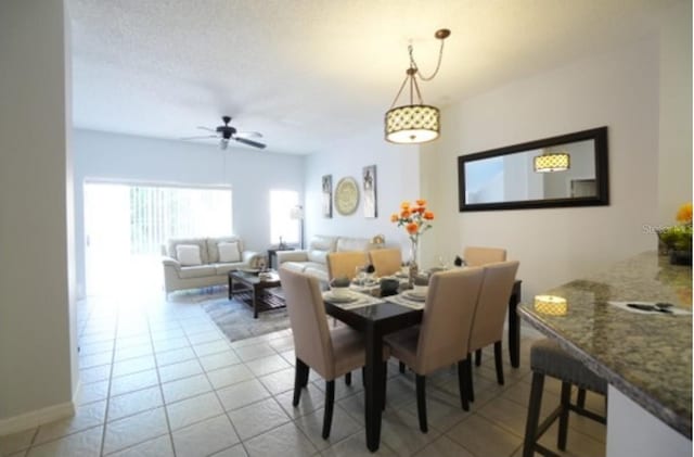 dining space with ceiling fan and light tile patterned floors