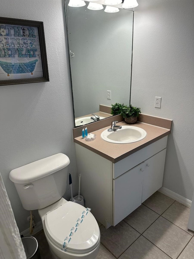 bathroom featuring vanity, toilet, and tile patterned floors