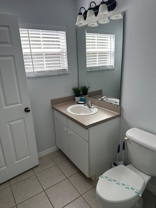 bathroom with tile patterned flooring, vanity, and toilet