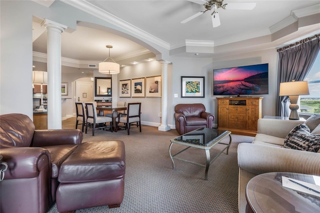 living room featuring crown molding, decorative columns, carpet, and ceiling fan