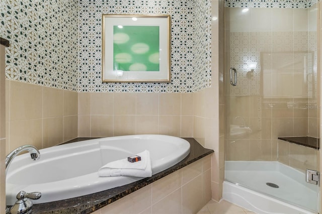 bathroom with separate shower and tub, tile walls, and tile patterned floors