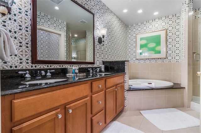 bathroom with tile patterned flooring, vanity, and separate shower and tub