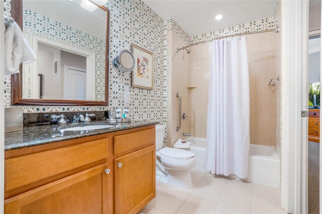 full bathroom featuring vanity, tile patterned floors, toilet, and shower / bath combo