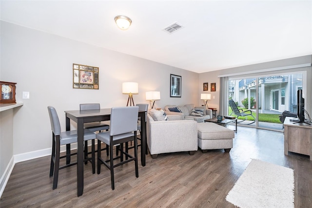 dining space featuring dark wood-type flooring