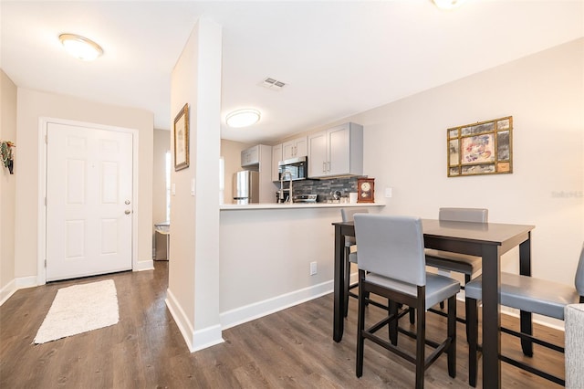 dining room featuring dark hardwood / wood-style flooring