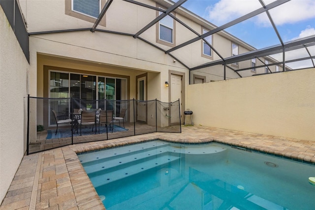 view of swimming pool featuring a lanai and a patio