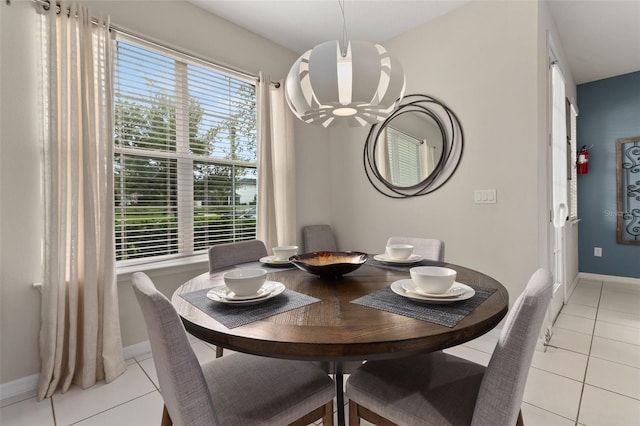 tiled dining area with a chandelier