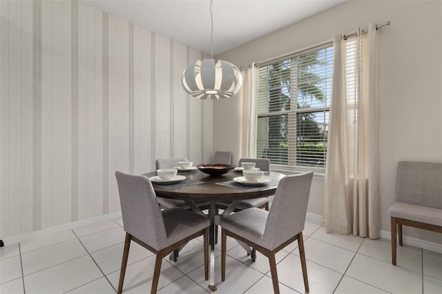 tiled dining space featuring a chandelier