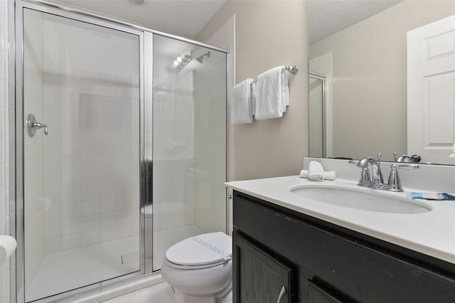 bathroom with walk in shower, vanity, and toilet