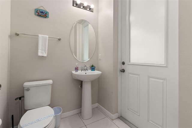 bathroom with tile patterned flooring, sink, and toilet