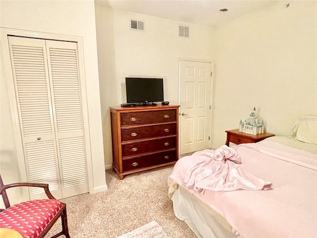 bedroom featuring light carpet and a closet