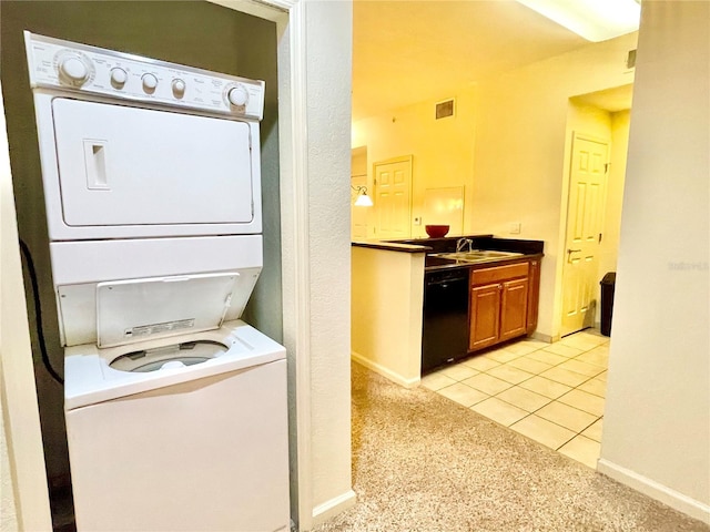 laundry area with light colored carpet, sink, and stacked washer and dryer