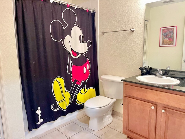 bathroom with toilet, tile patterned floors, and vanity