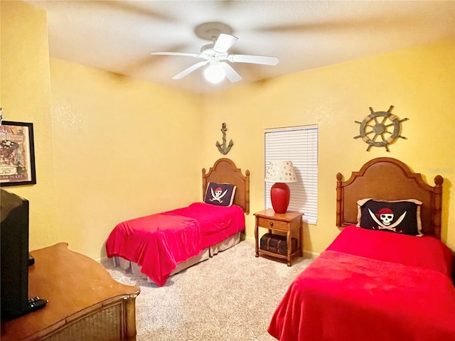 bedroom featuring ceiling fan and carpet