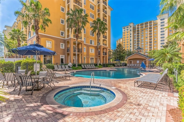 view of pool with a community hot tub and a patio