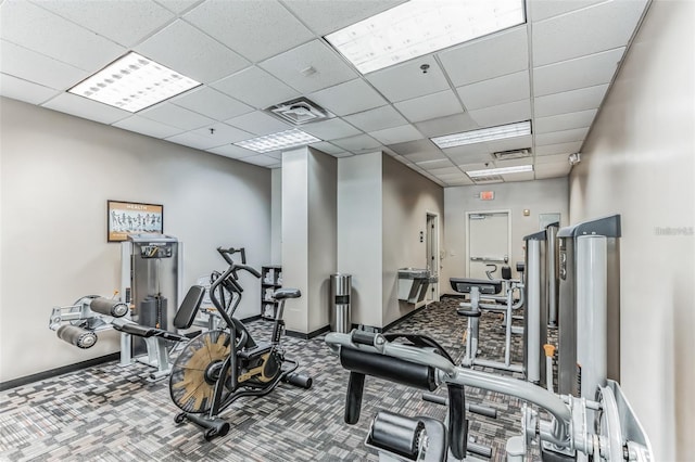 gym with carpet floors and a drop ceiling