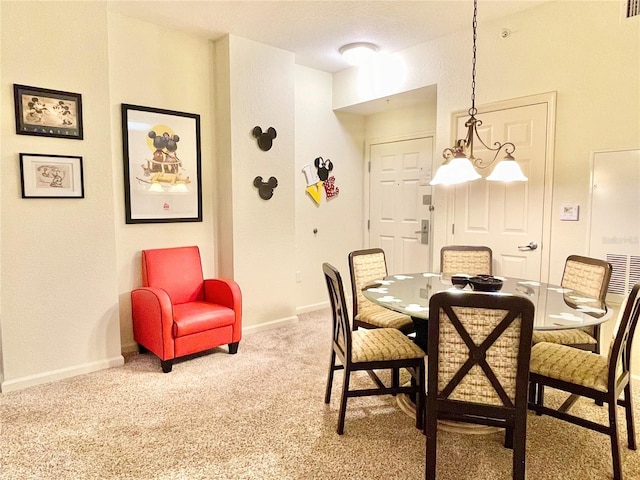 dining area with an inviting chandelier and carpet floors