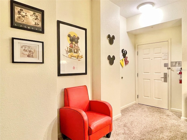 interior space with a textured ceiling and light colored carpet