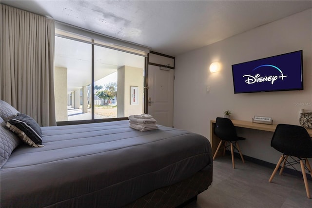 bedroom with tile patterned floors and baseboards