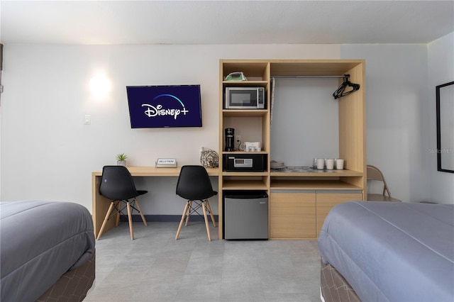 bedroom featuring stainless steel fridge