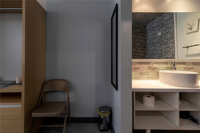 bathroom with a sink and backsplash