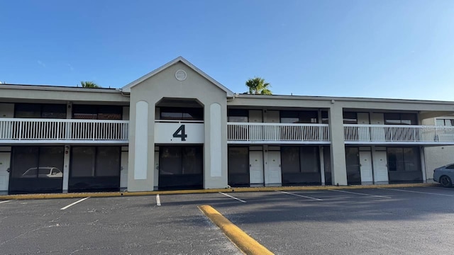 view of building exterior with uncovered parking