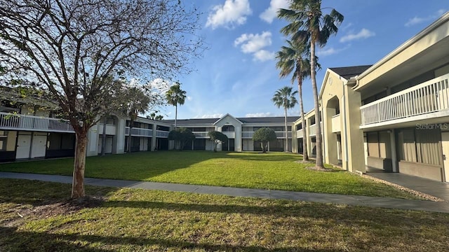 view of home's community featuring a residential view and a yard