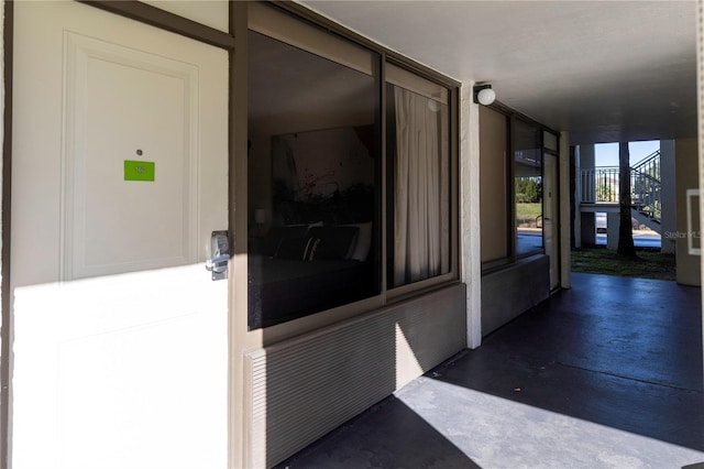 hallway featuring expansive windows and finished concrete flooring