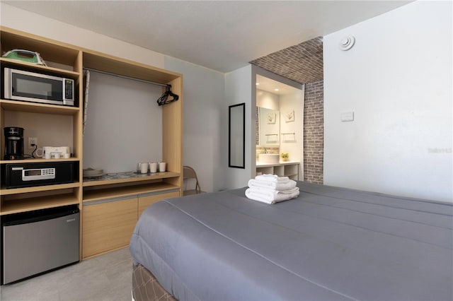 bedroom featuring fridge