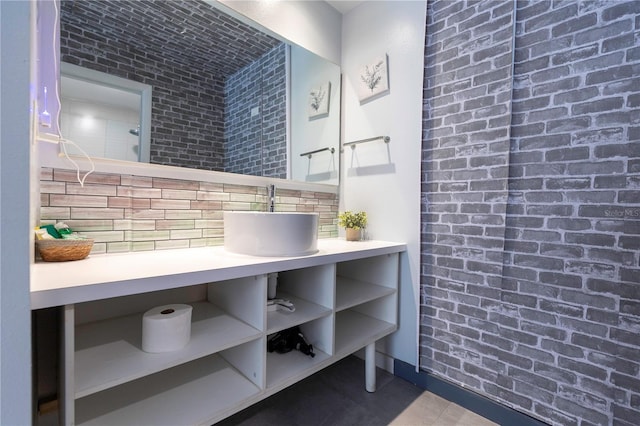 bathroom featuring baseboards and a sink