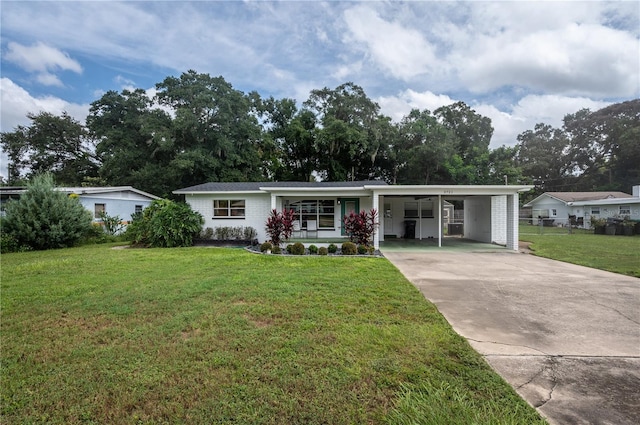 single story home with a front lawn and a carport