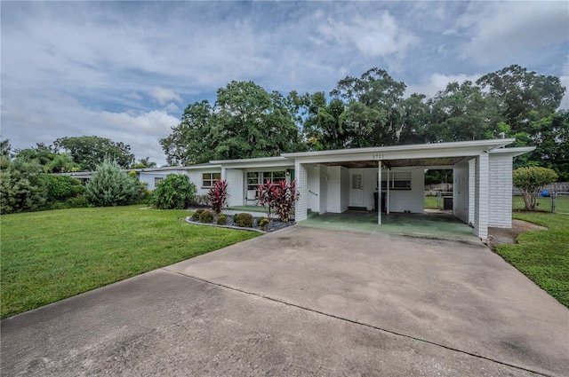 ranch-style house with a front yard and a carport