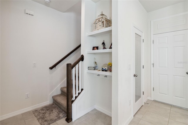 stairway featuring tile patterned floors