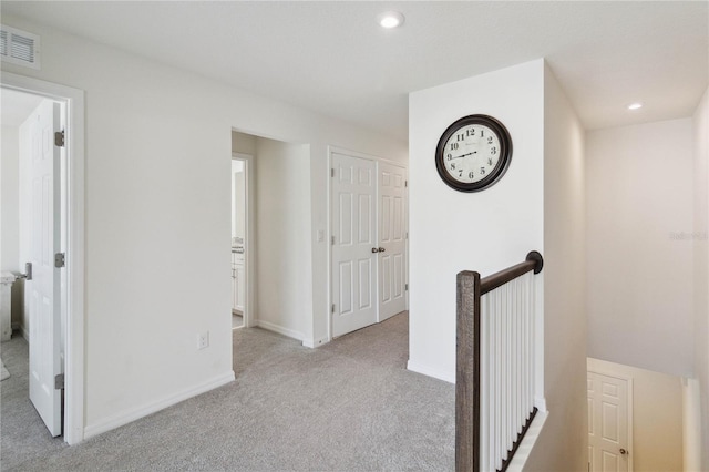 hallway with light carpet