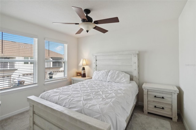 bedroom featuring ceiling fan and light carpet