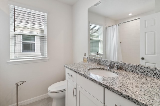 bathroom featuring tile patterned floors, curtained shower, vanity, and toilet