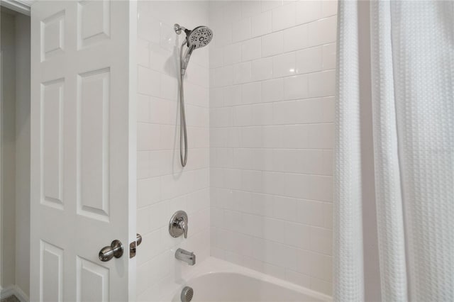 bathroom with shower / bathtub combination with curtain