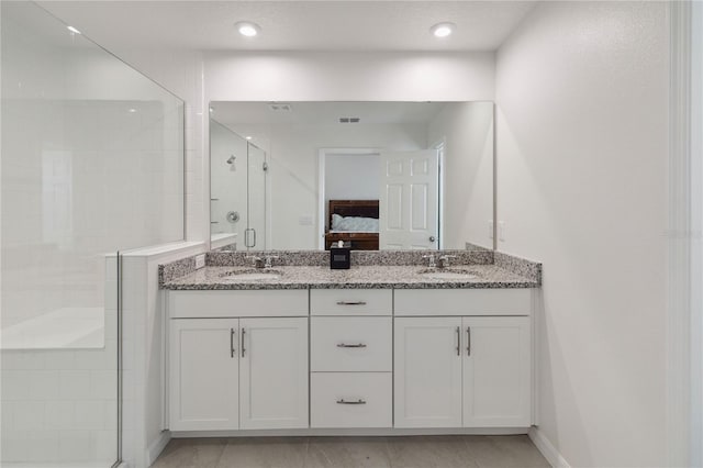 bathroom with walk in shower and vanity