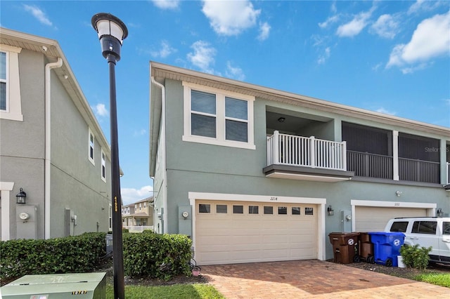 view of front of home with a balcony and a garage