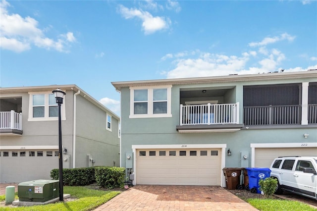 multi unit property with a balcony and a garage