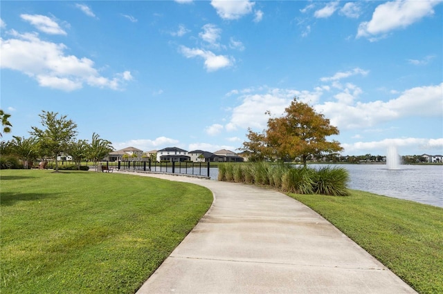 surrounding community featuring a water view and a yard