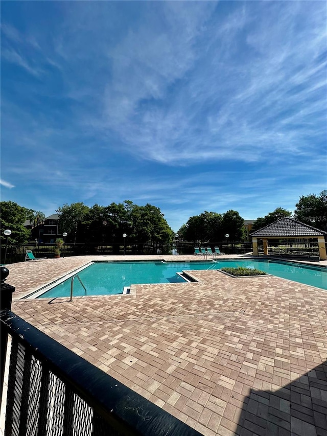 view of swimming pool featuring a gazebo and a patio