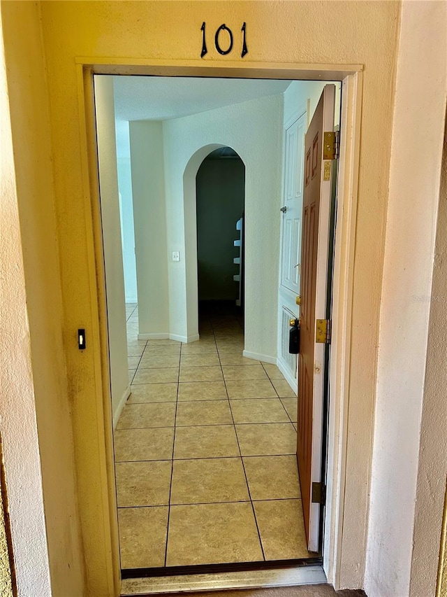 corridor with light tile patterned flooring