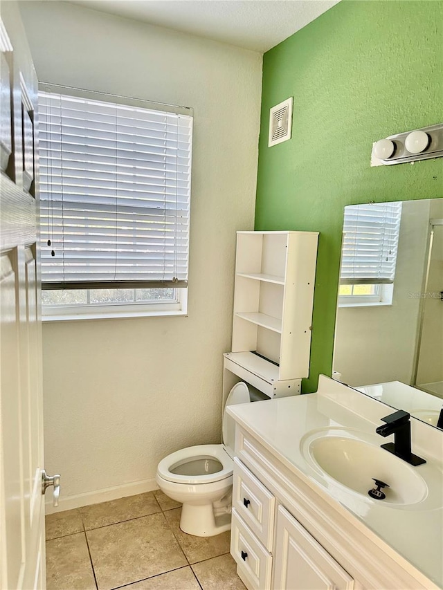 bathroom featuring tile patterned flooring, vanity, and toilet