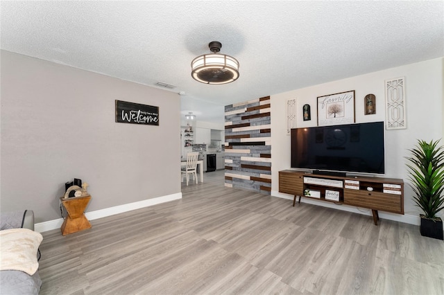 living room featuring a textured ceiling and hardwood / wood-style floors