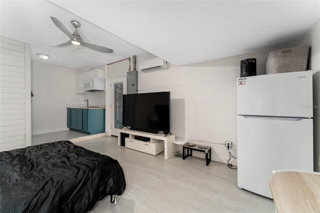 bedroom featuring electric panel, sink, an AC wall unit, white fridge, and ceiling fan