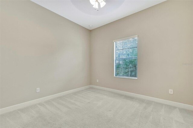 carpeted empty room featuring ceiling fan