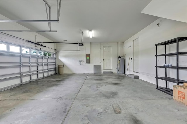 garage with electric panel, a garage door opener, and water heater