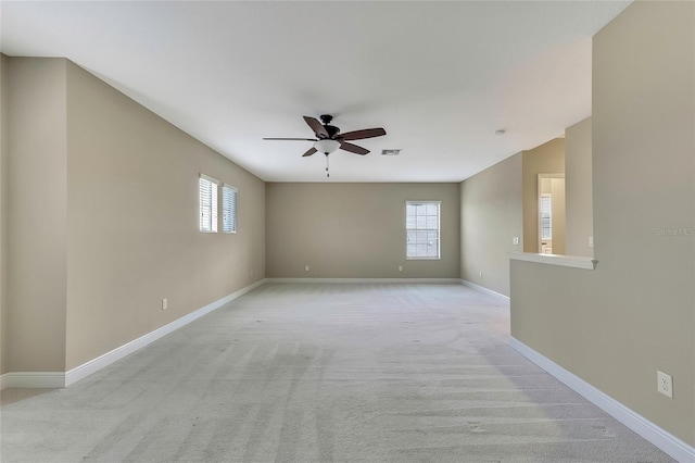 carpeted empty room featuring ceiling fan