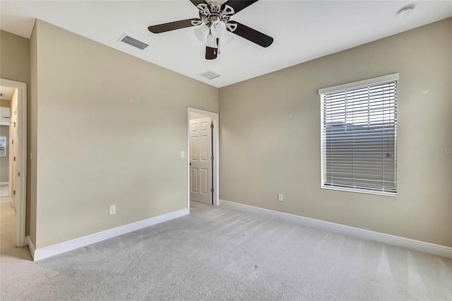 unfurnished room featuring light carpet and ceiling fan